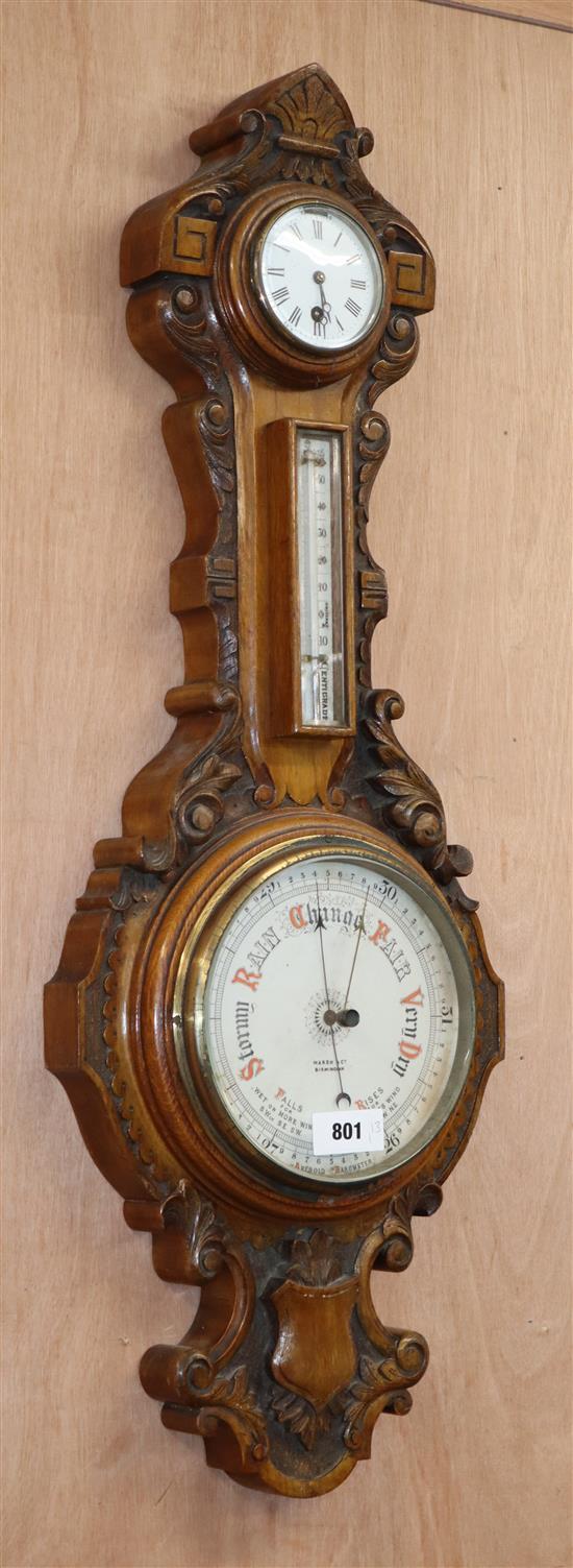 A late Victorian oak aneroid barometer, thermometer and timepiece H.89cm